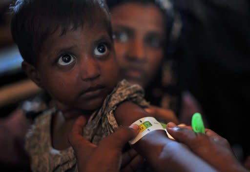 A Muslim Rohingya child receives medical care at a clinic on the outskirts of Sittwe on November 2. The UN's refugee agency has begun airlifting tents to provide shelter for thousands of people displaced by sectarian unrest in Myanmar's western Rakhine State