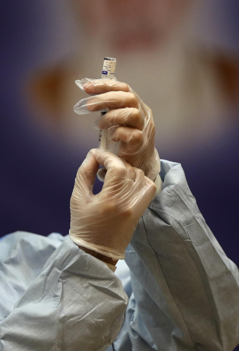 FILE — In this Feb. 9, 2021 file photo, a medic prepares a shot of Russian Sputnik V coronavirus vaccine for injection in a staged event at Imam Khomeini hospital in Tehran, Iran. Iran has finalized a deal with Russia over purchasing 60 million doses of the Sputnik V Coronavirus vaccine, state-run IRNA news agency reported Thursday, April 15, 2021. (AP Photo/Vahid Salemi, File)