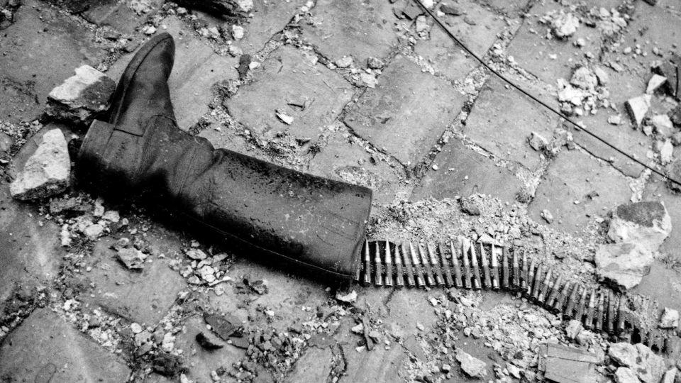 In the coastal town of Saint-Malo, France, where Allied and German forces clashed in 1944, Miller snapped an image of a tall boot on the ground, an ammunition belt snaking out like fish bones. - Lee Miller Archives, England 2023