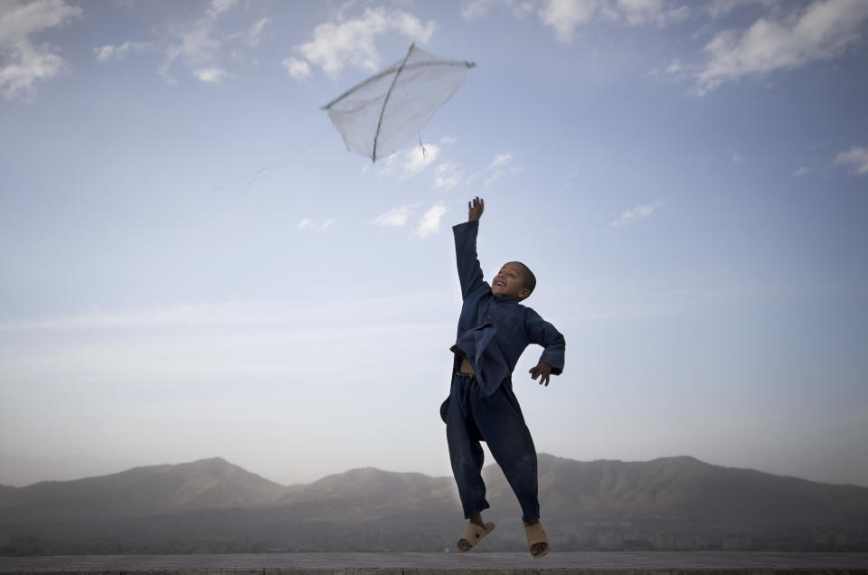 FILE - In this May 13, 2013 file photo made by Associated Press photographer Anja Niedringhaus, an Afghan boy flies his kite on a hill overlooking Kabul, Afghanistan. Niedringhaus, 48, an internationally acclaimed German photographer, was killed and an AP reporter was wounded on Friday, April 4, 2014 when an Afghan policeman opened fire while they were sitting in their car in eastern Afghanistan. (AP Photo/Anja Niedringhaus, File)