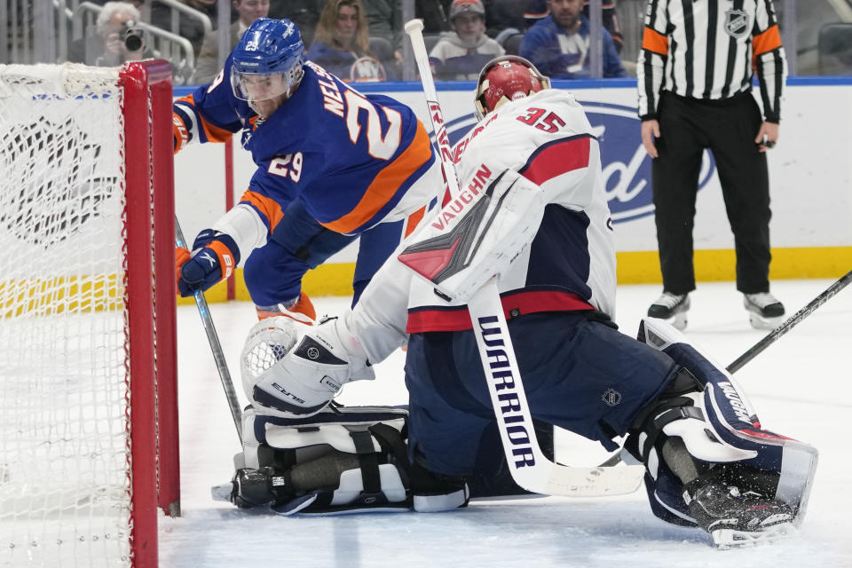 Washington Capitals goaltender Darcy Kuemper (35) makes a save against New York Islanders center Brock Nelson (29) during the second period of an NHL hockey game Saturday, March 11, 2023, in Elmont, N.Y. (AP Photo/Mary Altaffer)