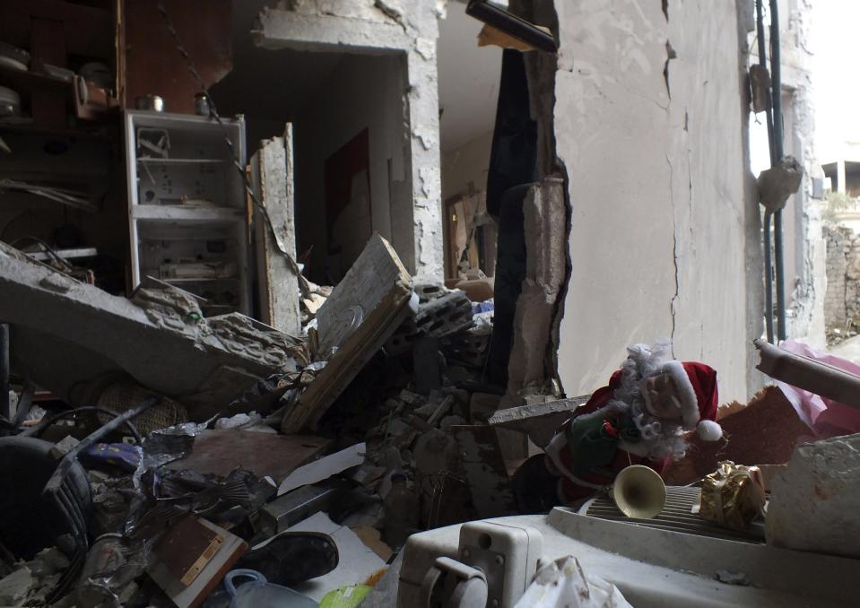 A Christmas toy lies among the damage in the besieged area of Homs