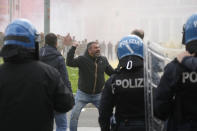 Roma fans riot with police ahead the Italian Serie A soccer match between Lazio and Roma at Rome's Olympic stadium, Sunday, March 19, 2023. (AP Photo/Gregorio Borgia)