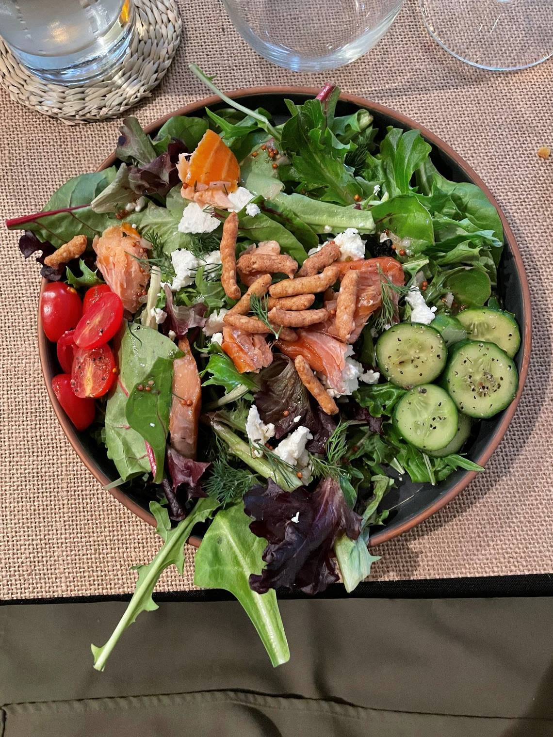 A salad of smoked salmon, fresh goat cheese, arugula, cucumber and a dill-lemon dressing helped get a recent Under The Table dinner underway. Amos Rothstein