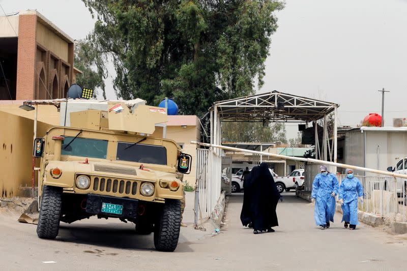 A military vehicle of Iraqi security forces is seen at the main entrance of Ibn Khatib hospital where a fire was sparked by an oxygen tank explosion, in Baghdad