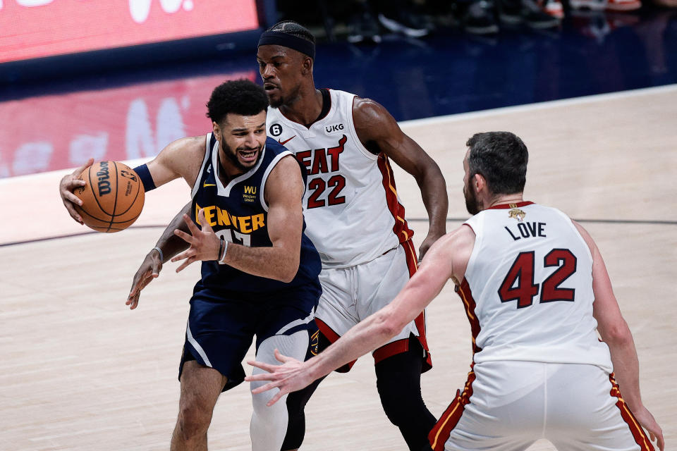 Denver Nuggets guard Jamal Murray controls the ball under pressure from Miami Heat forward Jimmy Butler and forward Kevin Love in Game 2 of the 2023 NBA Finals at Ball Arena in Denver on June 4, 2023. (Isaiah J. Downing/USA TODAY Sports)