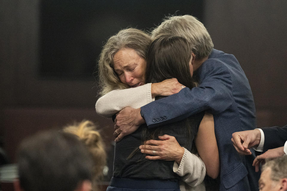 Parents of Anna Moriah Wilson, Karen Wilson and Eric Wilson, embrace Caitlin Cash, friend of Anna "Mo" Wilson, following the sentencing portion of Kaitlin Armstrong's murder trial at the Blackwell-Thurman Criminal Justice Center on Friday, Nov. 17, 2023, in Austin, Texas. Armstrong was found guilty of killing Anna Moriah Wilson in May 2022 and sentenced to 90 years in prison. (Mikala Compton/Austin American-Statesman via AP, Pool)