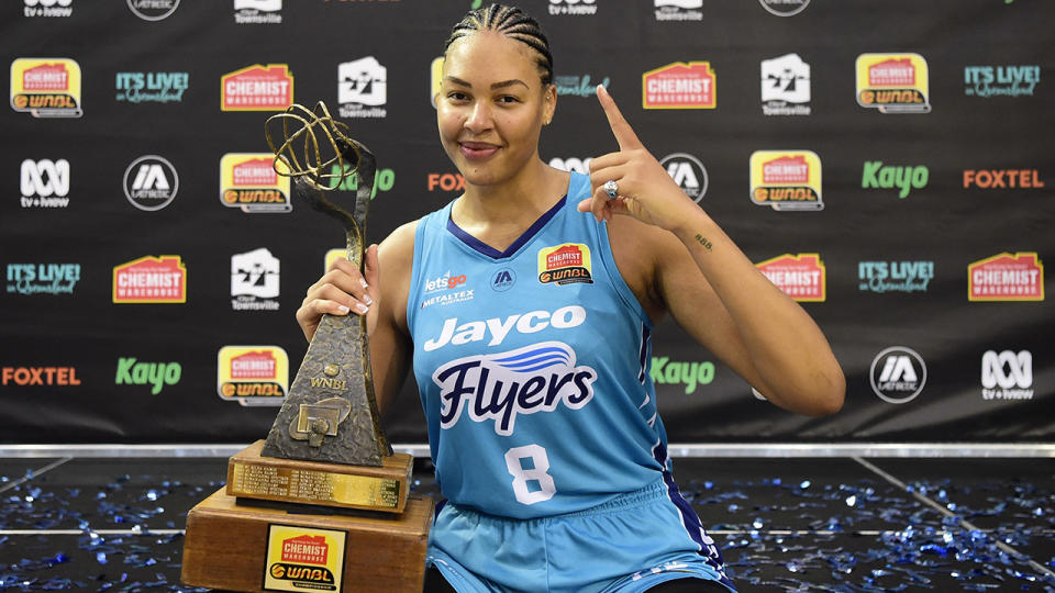 Liz Cambage, pictured here with the trophy after winning the WNBL title.