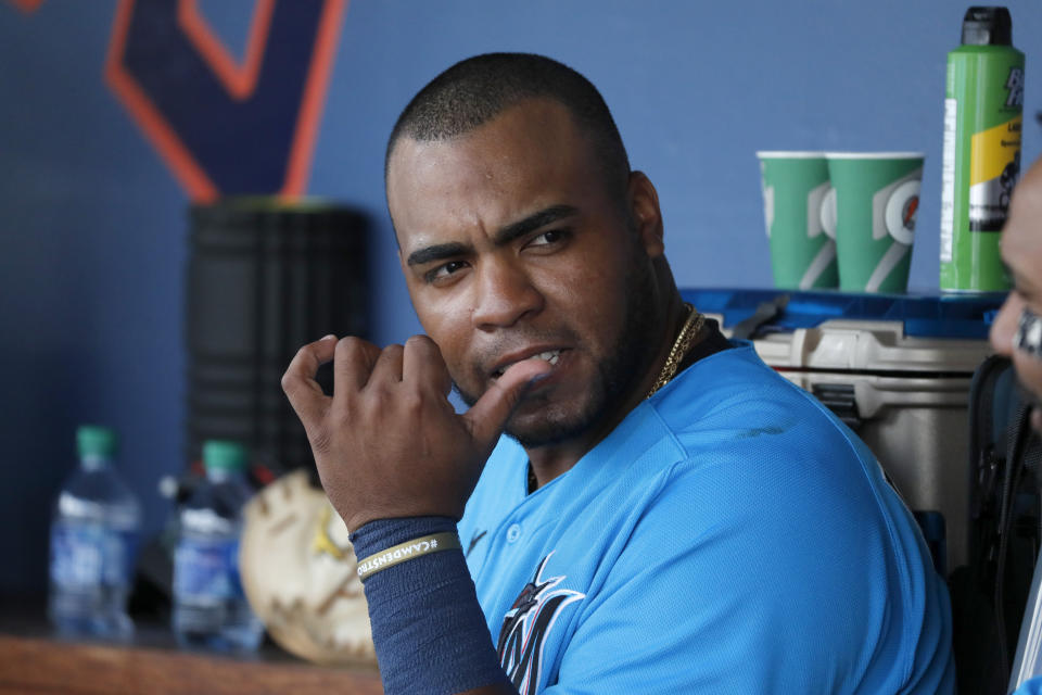 FILE — In this March 2, 2020, file photo, Miami Marlins' Jesus Aguilar sits in the dugout during a spring training baseball game against the Washington Nationals in West Palm Beach, Fla. Slugger Jesus Aguilar came to the Miami Marlins to find his swing and regain his confidence. If he does, he’ll provide a big boost to a team that finished last in the majors in home runs in 2019. (AP Photo/Jeff Roberson, File)