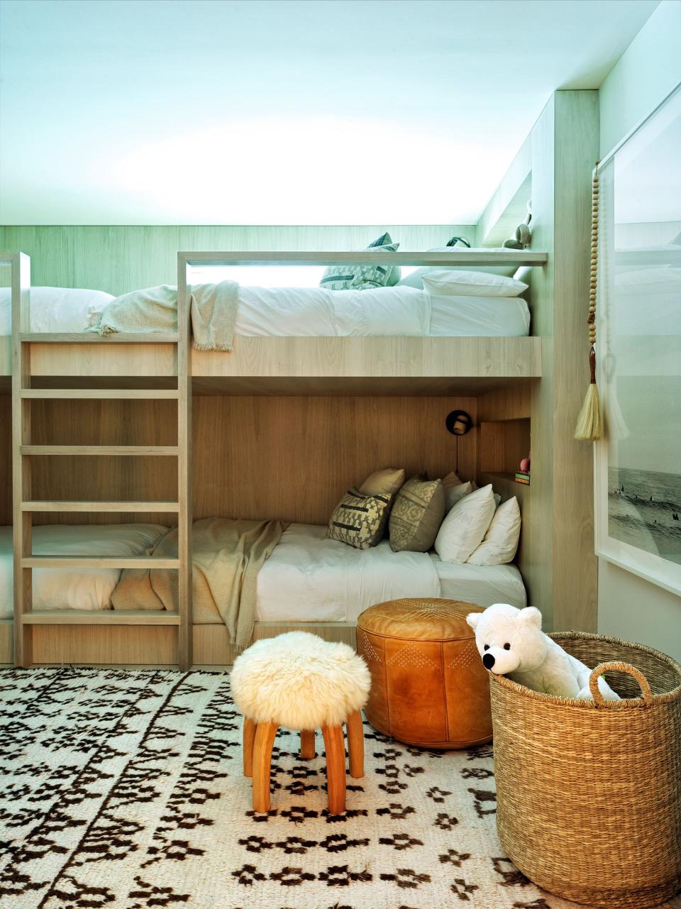 Alexander Design created the custom bleached walnut bunk beds for Rice’s daughters’ cozy room, complete with Parachute bedding, Teixidors throws, vintage pillows, a Moroccan pouf and rug, and a Clic sheepskin stool. A Michael Dweck photograph from Rice’s collection hangs on the wall.