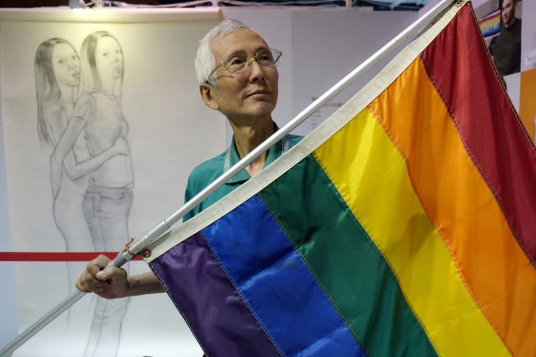 Taiwanese gay rights campaigner Chi Chia-wei, 59, poses for a photograph with a flag. Taiwan could become the first place in Asia to legalise gay marriage on Wednesday when a court makes a landmark ruling on whether to allow same-sex unions 