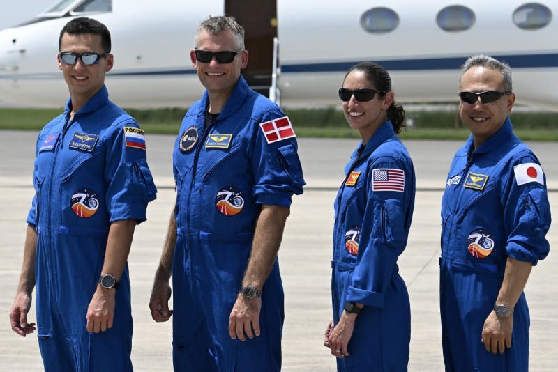 Left to right, members of the next NASA-SpaceX crew, Roscosmos cosmonaut Konstantin Borisov, ESA astronaut Andreas Morgensen, NASA astronaut Jasmin Moghbeli and JAXA astronaut Satoshi Furukawa pose to display their nations' flags after they arrived at Kennedy Space Center in Florida on Sunday. Photo by Joe Marino/UPI