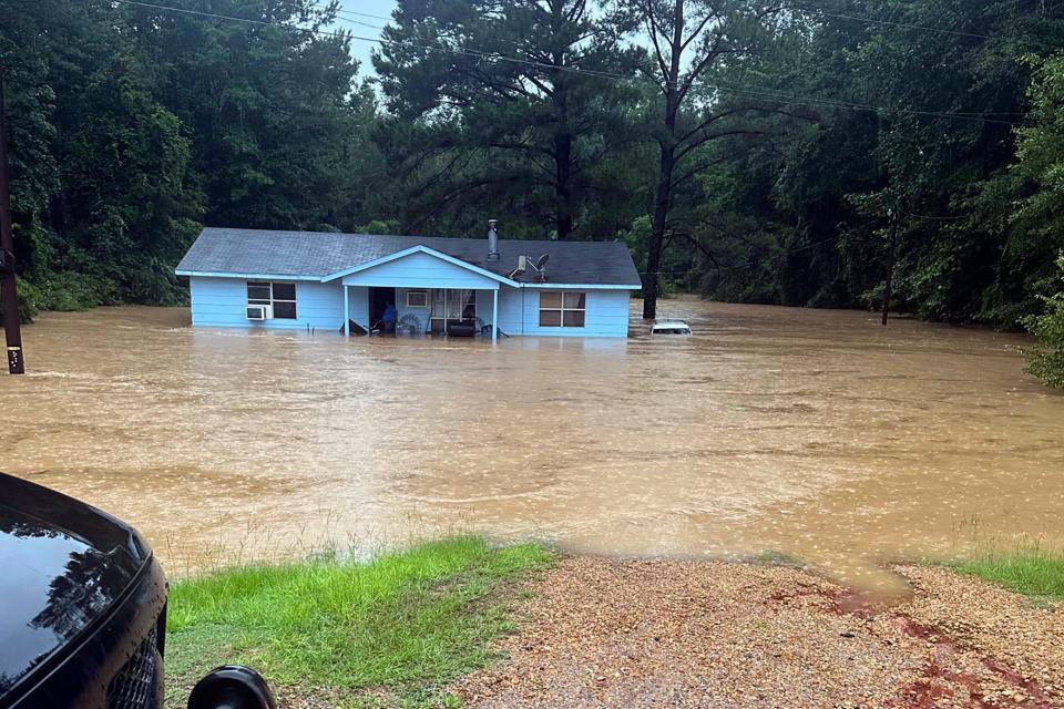 In this image provided by Mississippi state Rep. Michael Evans, floodwaters surround a home in Louisville, Miss., Thursday, July 13, 2023. Flash flooding was also reported Thursday in Winston, Choctaw, Neshoba and Noxubee counties.