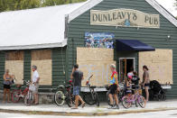 With most people off work and it looking like the Charleston, S.C., area will be spared from destructive winds many people biked to Dunleavy's Pub, one of the few open restaurants, on Sullivan's Island, S.C., as Hurricane Florence spins out in the Atlantic ocean Thursday, Sept. 13, 2018. (AP Photo/Mic Smith)