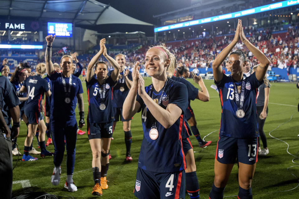 U.S. defender Becky Sauerbrunn (4), forward Lynn Williams (13) and teammates acknowledge fans after a 3-1 win over Japan in a SheBelieves Cup soccer match Wednesday, March 11, 2020, in Frisco, Texas. (AP Photo/Jeffrey McWhorter)