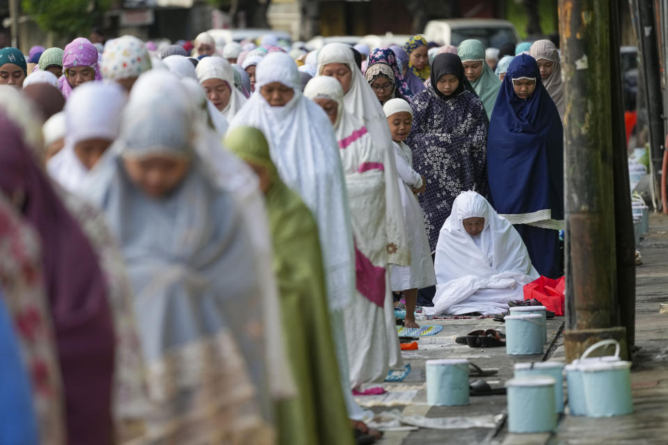 Muslims perform a morning prayer marking the Eid al-Adha holiday on a street in Jakarta, Indonesia, Thursday, June 29, 2023. Muslims around the world will celebrate Eid al-Adha, or the Feast of the Sacrifice, slaughtering sheep, goats, cows and camels to commemorate Prophet Abraham's readiness to sacrifice his son Ismail on God's command. (AP Photo/Tatan Syuflana)