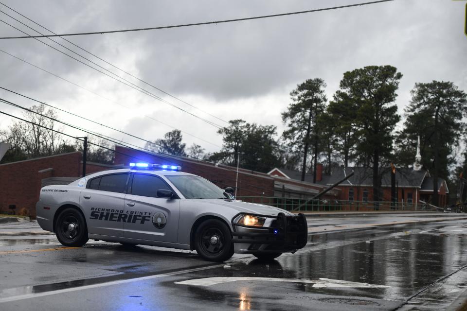 The Richmond County Sheriff's Office blocks Jackson Road after a tree fell on a power line on Tuesday, Jan. 9, 2024. A large storm front moved through the area in the afternoon, bringing a severe thunderstorm warning and a tornado watch.