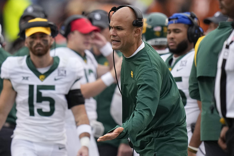 Baylor head coach Dave Aranda reaches out to his players during the second half of an NCAA college football game against Texas in Austin, Texas, Friday, Nov. 25, 2022. (AP Photo/Eric Gay)