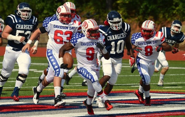 Davidson Day running back Jordan Brown (9) shows off the American flag uniforms on a touchdown run -- Charlotte Observer