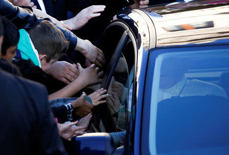 Pope Francis (R) waves from his car as he leaves after his visit at the Basilica of Saint Bartholomew on Tiber island in Rome, April 22, 2017. REUTERS/Alessandro Bianchi