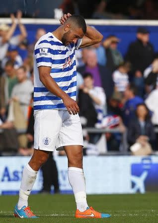 Queens Park Rangers Steven Caulker reacts after scoring an own-goal during their English Premier League soccer match against Liverpool at Loftus Road in London October 19, 2014. REUTERS/Eddie Keogh