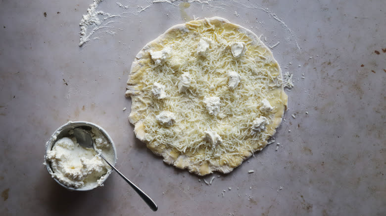 Ricotta on mozzarella pizza dough