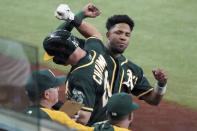 Oakland Athletics' Elvis Andrus congratulates Matt Chapman (26) after his first-inning home run against the Texas Rangers in the first inning of a baseball game Tuesday, June 22, 2021, in Arlington, Texas. (AP Photo/Louis DeLuca)