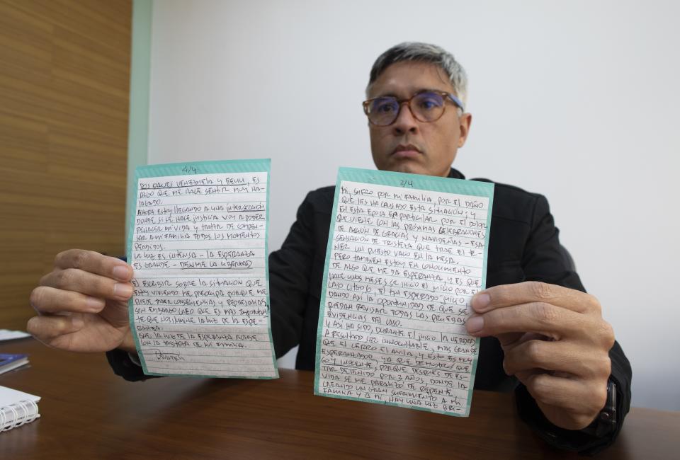 FILE - Jesus Loreto, an attorney representing Tomeu Vadell, one of six U.S. oil executives jailed for three years in Venezuela, shows a letter written by Vadell, in Caracas, Venezuela, Wednesday, Nov. 25, 2020. In a calm if desperate-sounding voice Eyvin Hernandez, a Los Angeles attorney detained for months in Venezuela, said in a Aug. 21, 2022 recording provided to The Associated Press, that he and other Americans imprisoned in Venezuela — at least 10, including five oil executives and three veterans — all feel "like our government has abandoned us." (AP Photo/Ariana Cubillos, File)