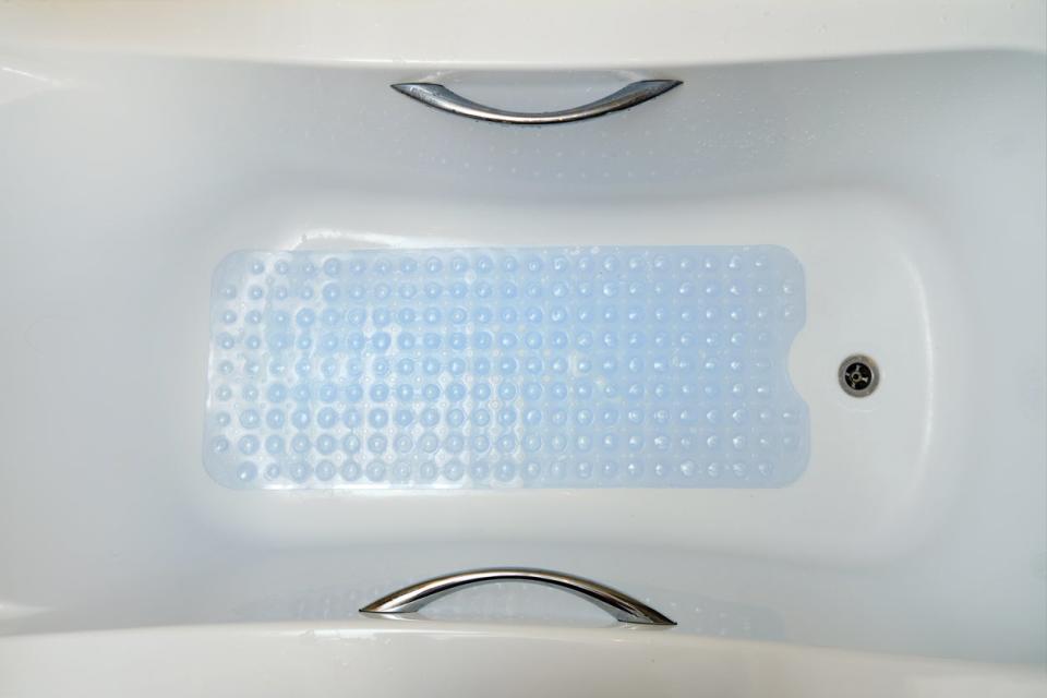 overhead view of tub with blue non-slip liner