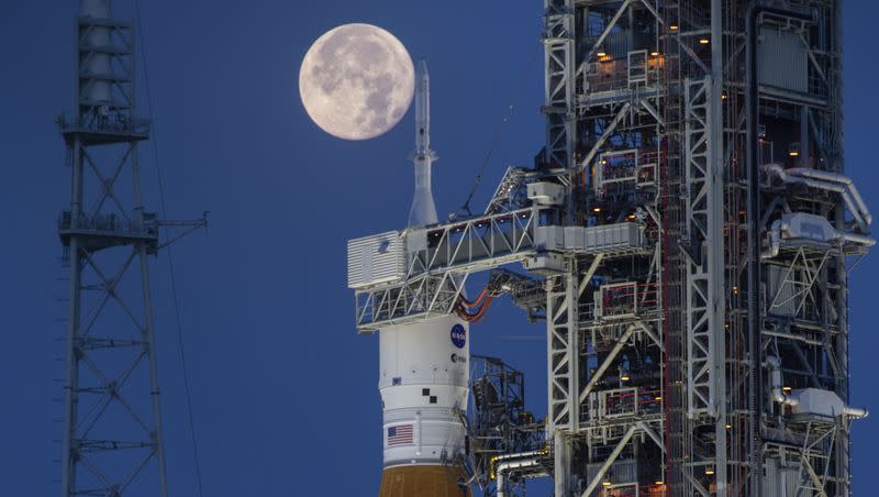 A full moon is seen behind the Artemis I Space Launch System and Orion spacecraft, atop the mobile launcher, are prepared for a wet dress rehearsal to practice timelines and procedures for launch, at Launch Complex 39B at NASA’s Kennedy Space Center in Florida on June 14, 2022. On Tuesday, Jan. 9, 2024, NASA said astronauts will have to wait until 2025 before flying to the moon and another few years before landing on it.