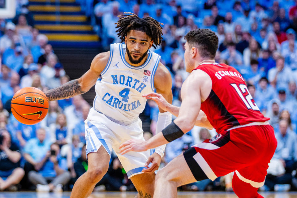 Mar 2, 2024; Chapel Hill, North Carolina, USA; North Carolina Tar Heels guard RJ Davis (4) is guarded by North Carolina State Wolfpack guard Michael O’Connell (12) during the second half at Dean E. Smith Center. Scott Kinser-USA TODAY Sports