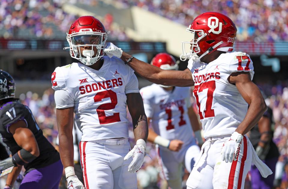 OU's running back Jovantae Barnes (2) celebrates with wide receiver Marvin Mims (17) after scoring a touchdown against TCU on Oct. 1.