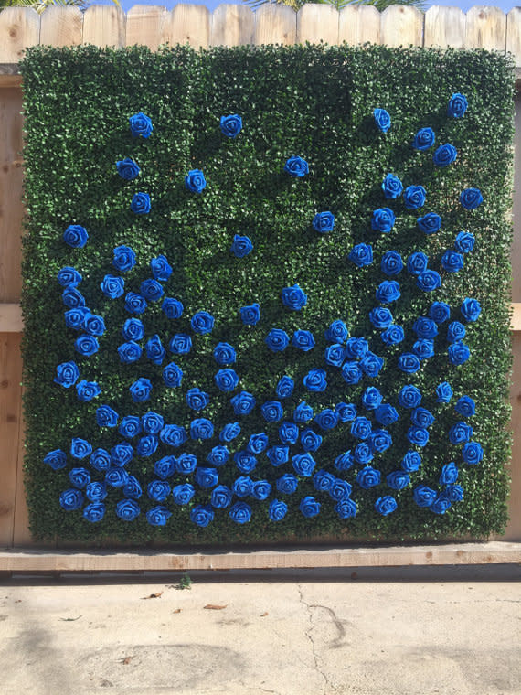 Organic-style walls made of boxwood are the new floral wall. The boxwood, <a href="https://www.etsy.com/listing/474673999/flower-wall-backdrop-boxwood-flower-wall?ga_order=most_relevant&amp;ga_search_type=all&amp;ga_view_type=gallery&amp;ga_search_query=boxwood%20backdrop&amp;ref=sr_gallery_8" target="_blank">like this one shown</a>, creates an earthy focal point for guest photos. It can also act as a frame for the sweetheart's table, or be used as the backdrop for the wedding cake table. Embrace the outdoors with this neutral wall that will seamlessly fit into any wedding's color palette.&nbsp;