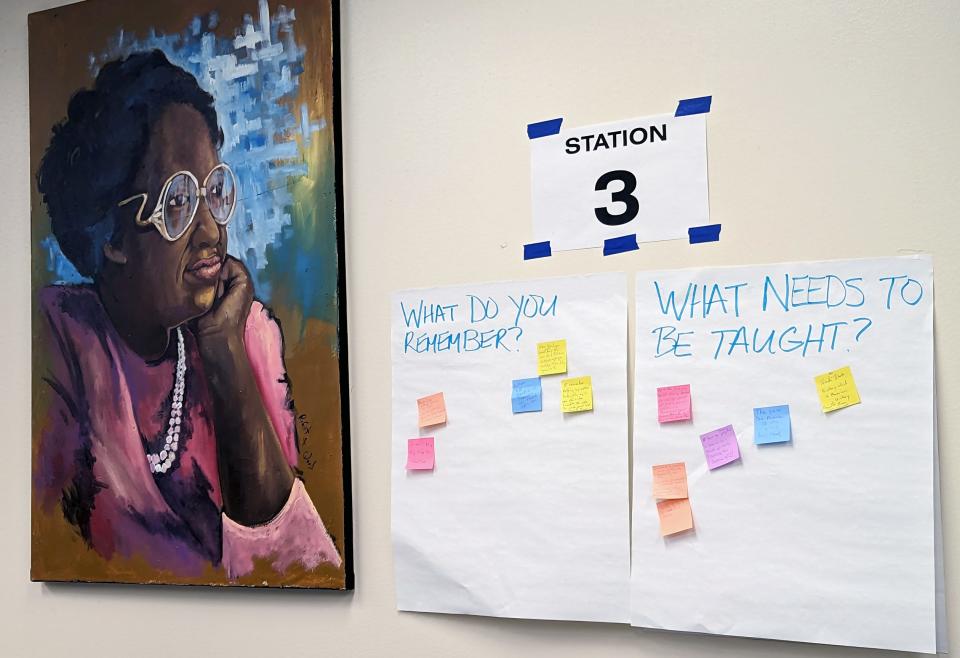 Notes with memories and suggestions from residents are seen along a wall next to a painting of Clara Luper inside the Ralph Ellison Library during a listening session for the upcoming Clara Luper Civil Rights Center.