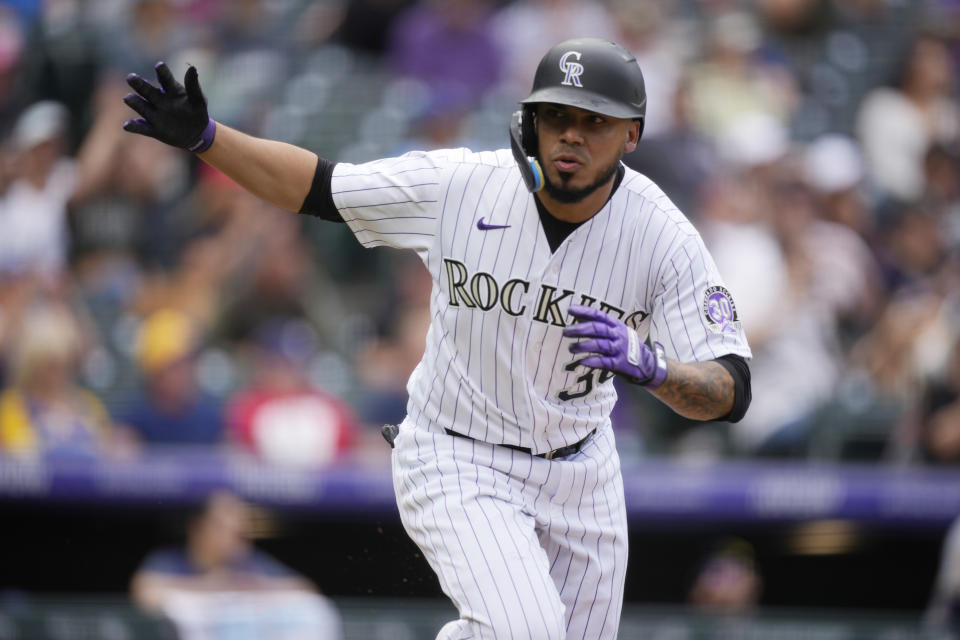 Colorado Rockies pinch-hitter Harold Castro heads up the first base line after connecting for a single to drive in two runs off Milwaukee Brewers relief pitcher Peter Strzelecki in the eighth inning of a baseball game Thursday, May 4, 2023, in Denver. (AP Photo/David Zalubowski)