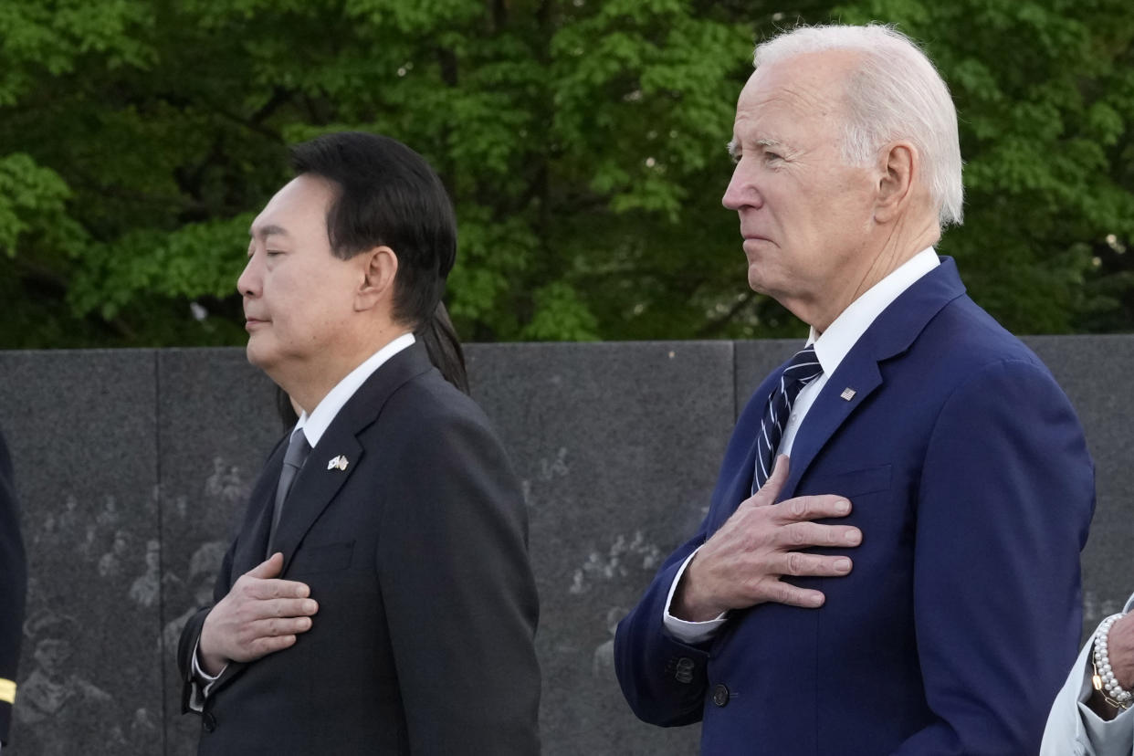 President Joe Biden and South Korea's President Yoon Suk Yeol pause after laying a wreath as they visit the Korean War Veterans Memorial in Washington, Tuesday, April 25, 2023. (AP Photo/Susan Walsh)