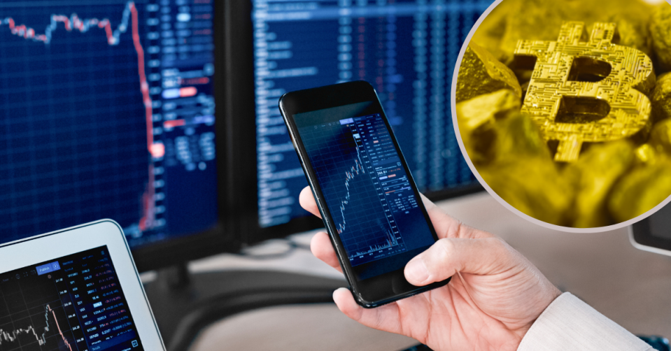 A hang holding a phone showing stock charts and a Bitcoin symbol