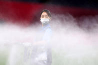 <p>A member of ground staff wearing a face mask waters the pitch at half time during the Men's First Round Group C match between Egypt and Spain during the Tokyo 2020 Olympic Games at Sapporo Dome on July 22, 2021 in Sapporo, Hokkaido, Japan. (Photo by Masashi Hara/Getty Images)</p> 