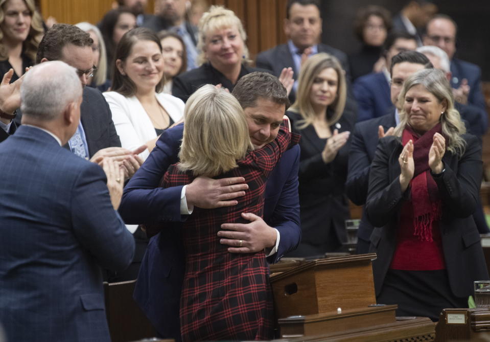 Leader of the Opposition Andrew Scheer is embraced by Deputy House leader Candice Bergen after he announced he will step down as leader of the Conservatives, Thursday Dec. 12, 2019 in the House of Commons in Ottawa. (Adrian Wyld/The Canadian Press via AP)