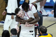 UConn center Youssouf Singare, rear, hugs orward Alex Karaban after the NCAA college basketball game against Alabama at the Final Four, Saturday, April 6, 2024, in Glendale, Ariz. (AP Photo/Ross D. Franklin)