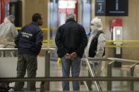 Police investigators work inside the Gare de Lyon station after an attack, Saturday, Feb. 3, 2024 in Paris. A man seemingly armed with a knife and a hammer injured three people Saturday in an early-morning attack at the major Gare de Lyon train station in Paris, another nerve-rattling security incident in the Olympic host city before the Summer Games open in six months. (AP Photo/Christophe Ena)