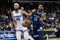 Memphis Grizzlies forward Jaren Jackson Jr. (13) handles the ball ahead of Sacramento Kings forward Marvin Bagley III (35) in the second half of an NBA basketball game Sunday, Nov. 28, 2021, in Memphis, Tenn. (AP Photo/Brandon Dill)