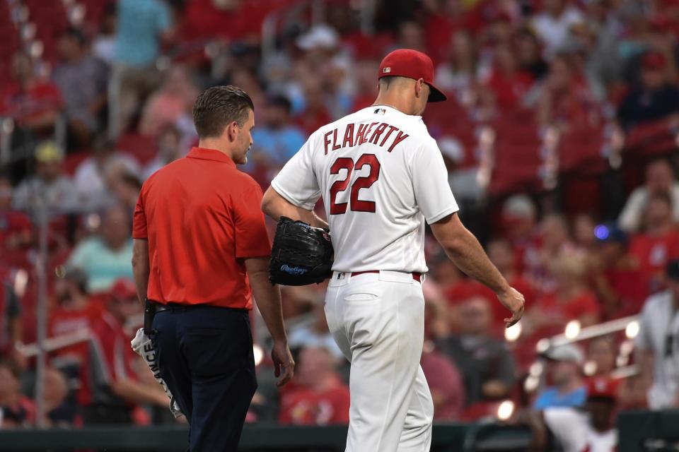 St. Louis Cardinals starting pitcher Jack Flaherty (22) leaves the field with a trainer after being pulled from the game against the Detroit Tigers during the third inning at Busch Stadium on August 24, 2021.