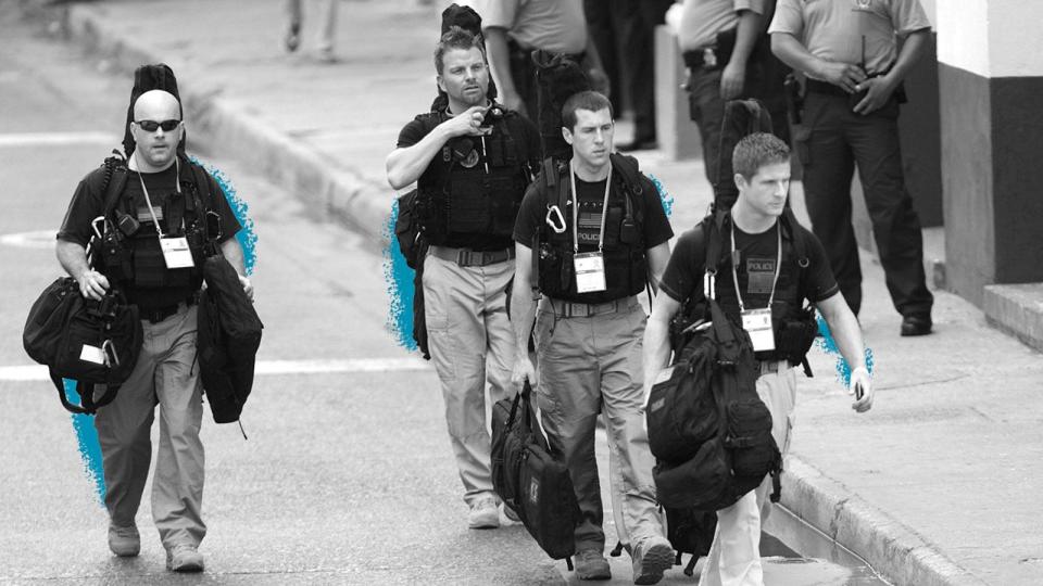 Secret service agents walk around the Convention Center in Cartagena, Colombia, prior to the opening ceremony of the 6th Summit of the Americas on April 14, 2012.