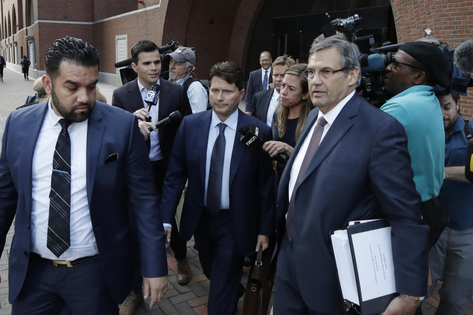 Devin Sloane, middle, leaves federal court after his sentencing in a nationwide college admissions bribery scandal, Tuesday, Sept. 24, 2019, in Boston. (AP Photo/Elise Amendola)