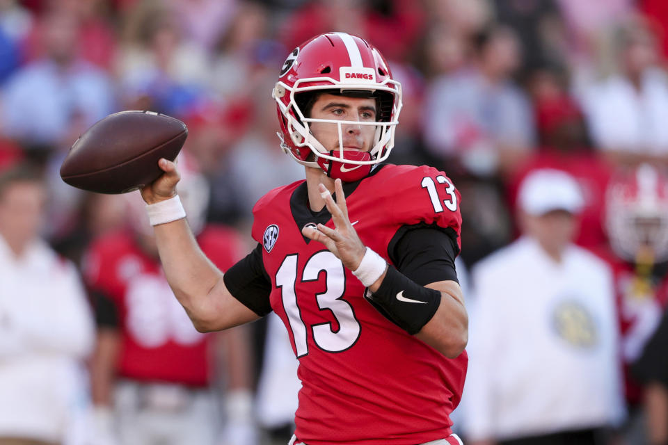 Georgia quarterback Stetson Bennett (13) throws a pass against Kentucky during the second half of an NCAA college football game Saturday, Oct. 16, 2021 in Athens, Ga. (AP Photo/Butch Dill)