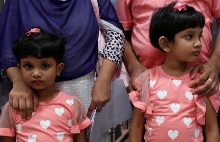 Shahzia (L), 5, and her sister Sanzida, 6, pose with their parents in Hong Kong June 16, 2016, after the family fled Bangladesh. REUTERS/Bobby Yip