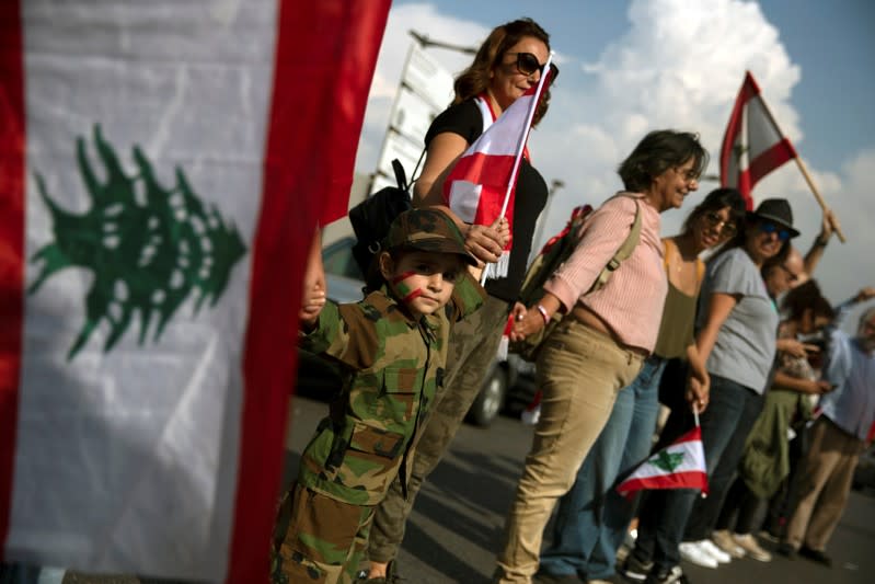 A girl takes part in a human chain organised by demonstrators during ongoing anti-government protests in Beirut