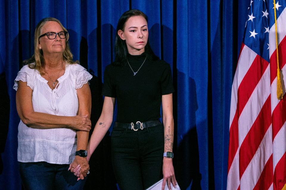 Crystal Probst, left, and her daughter, Taylor Probst, family members of Andreas Rene Probst, a cyclist who was intentionally struck in a series of hit-and-run crashes, wait to speak at a news conference on Tuesday, Sept. 19, 2023, in Las Vegas.