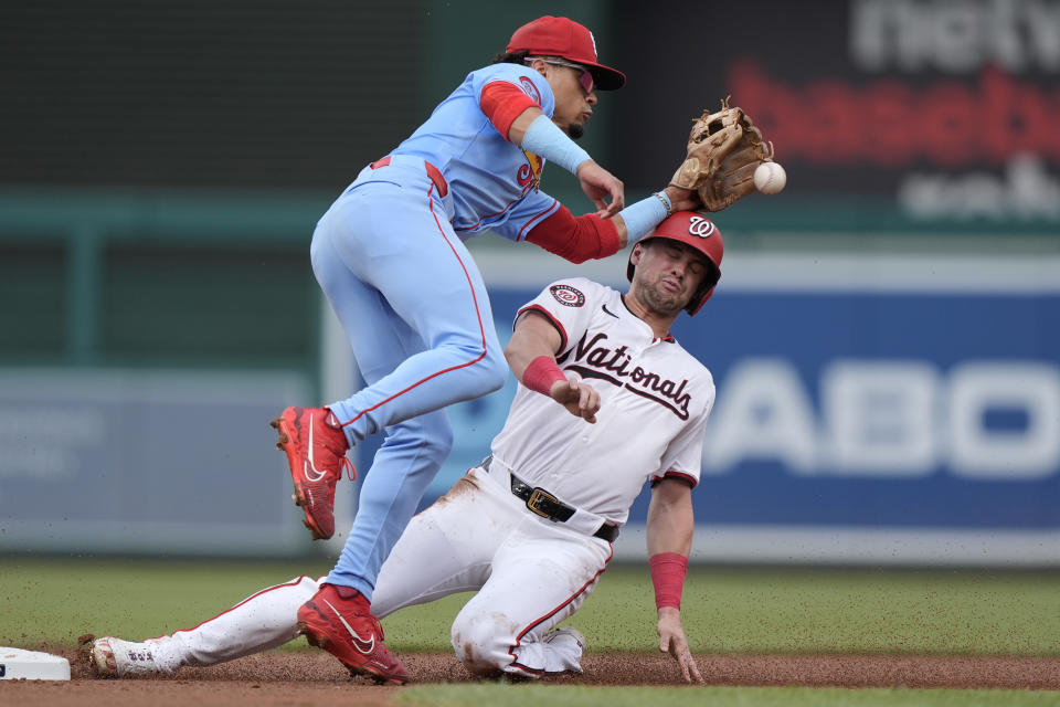 Washington Nationals' Lane Thomas, right, collides with St. Louis Cardinals shortstop Masyn Winn, left, while stealing second base during the first inning of a baseball game at Nationals Park, Saturday, July 6, 2024, in Washington. (AP Photo/Mark Schiefelbein)